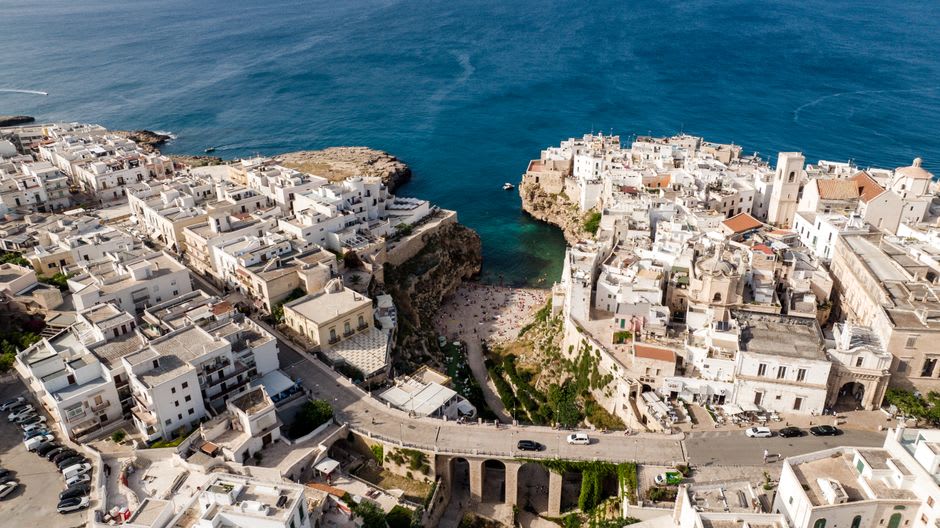 The crescent beach of Sperlonga with the whitewashed old town rising on the promontory behind it