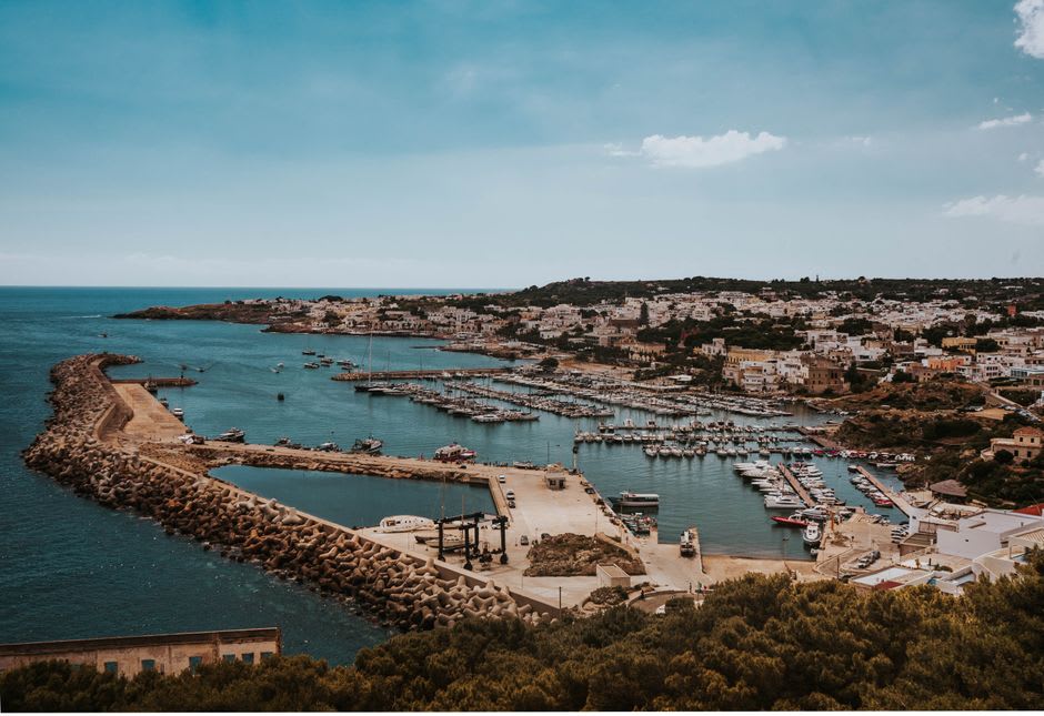 Stone ramparts of the Castello Aragonese in Otranto overlooking the deep blue Adriatic Sea at dawn