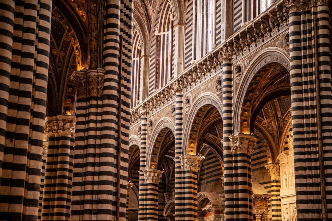 The black-and-white striped marble facade of Siena's Duomo