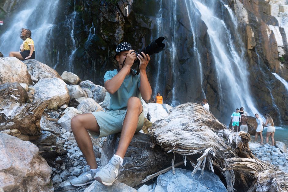 Tourists forming a human chain climbing the terraced rocks of Dunn's River Falls