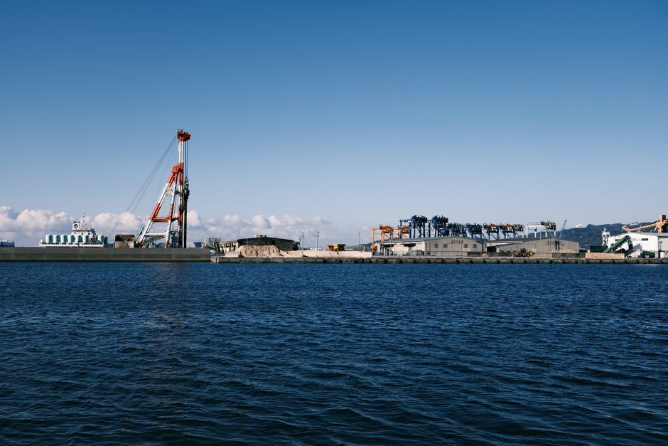 The white keep of Hirado Castle standing above the harbour and the red bridge to the island