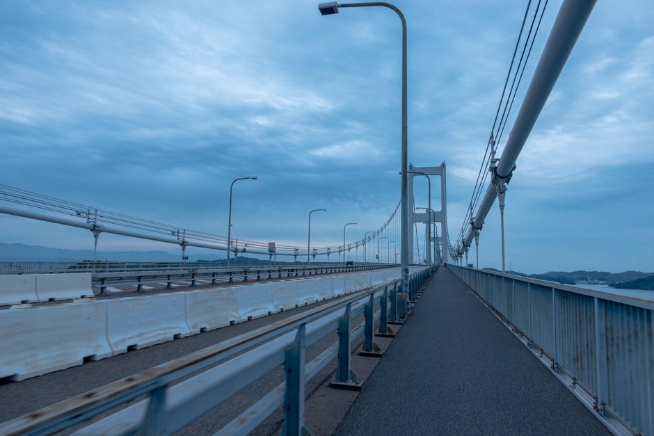 The dedicated cycling lane curving along the Kurushima-Kaikyō suspension bridge above the Seto Inland Sea