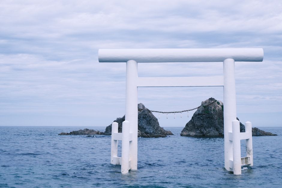 The Sakurai Futamigaura white torii and the married-couple rocks bound by straw rope at dusk