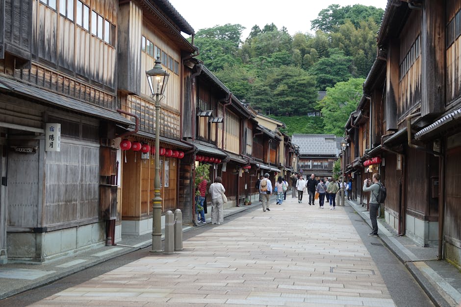 The dark wooden ochaya of Higashi Chaya district — latticed facades, narrow stone streets, and the quiet elegance of a geisha quarter that still functions