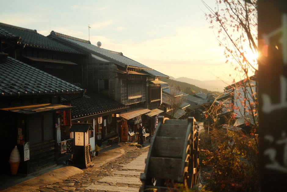 The wooden facade and gated entrance of the Toson Memorial Museum in Magome, set among the town's dark-timbered Edo-era buildings