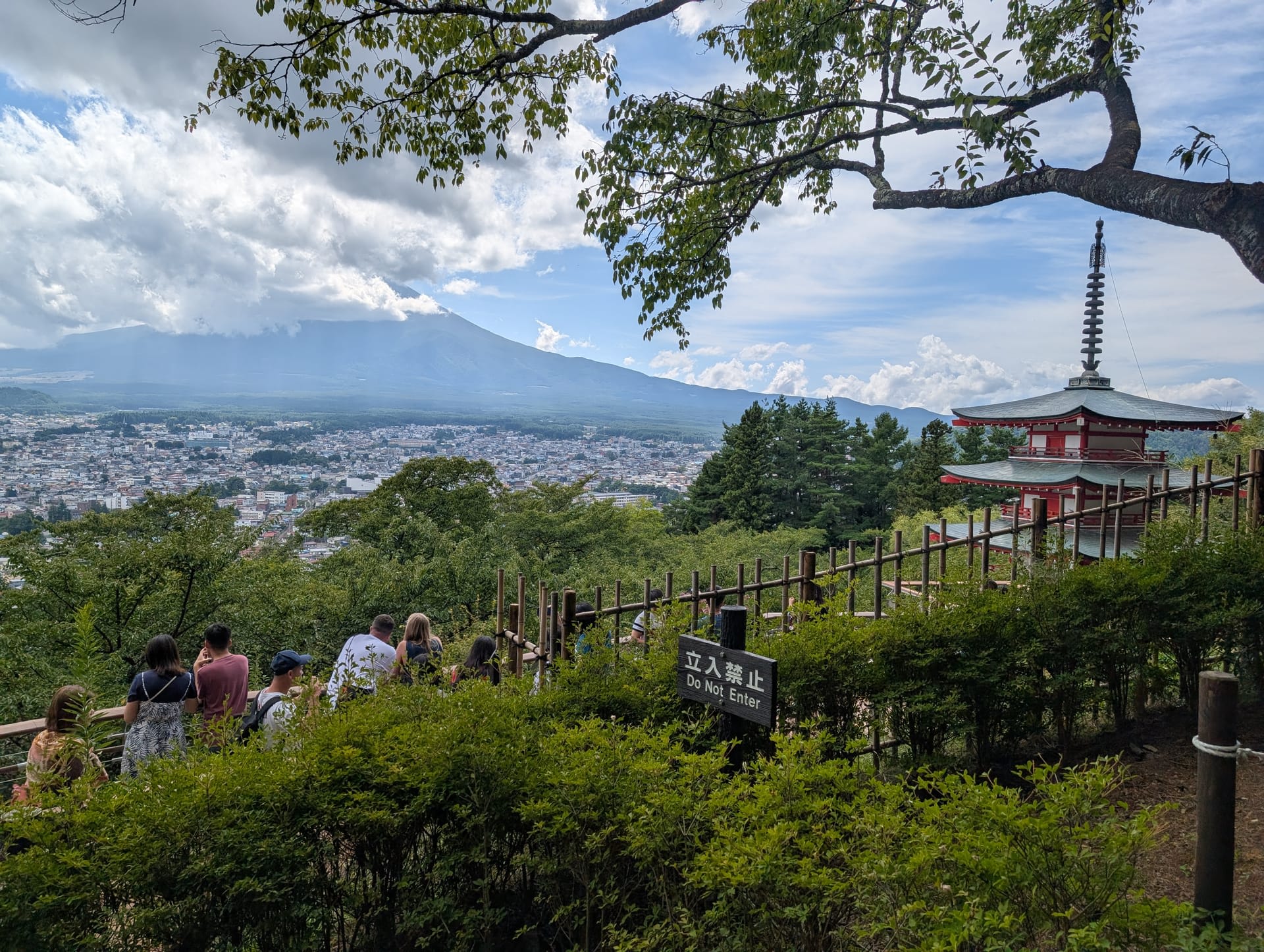 The observation platform at the pagoda viewpoint, with visitors looking out at Fuji and the city below