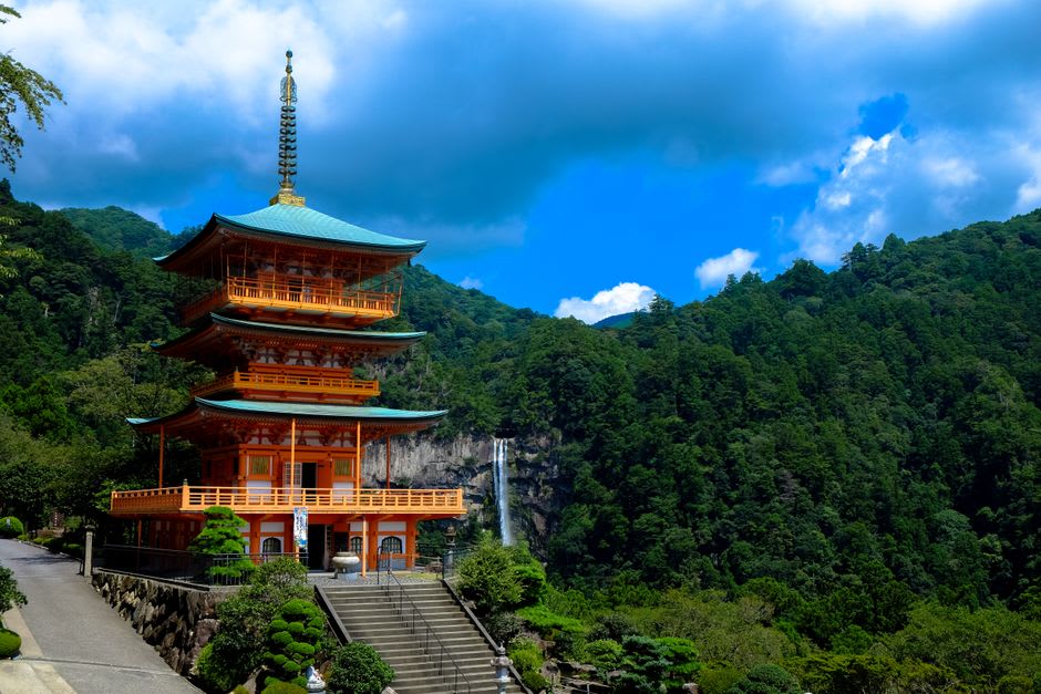 The vermilion pagoda of Seiganto-ji framed against the long single drop of Nachi Falls