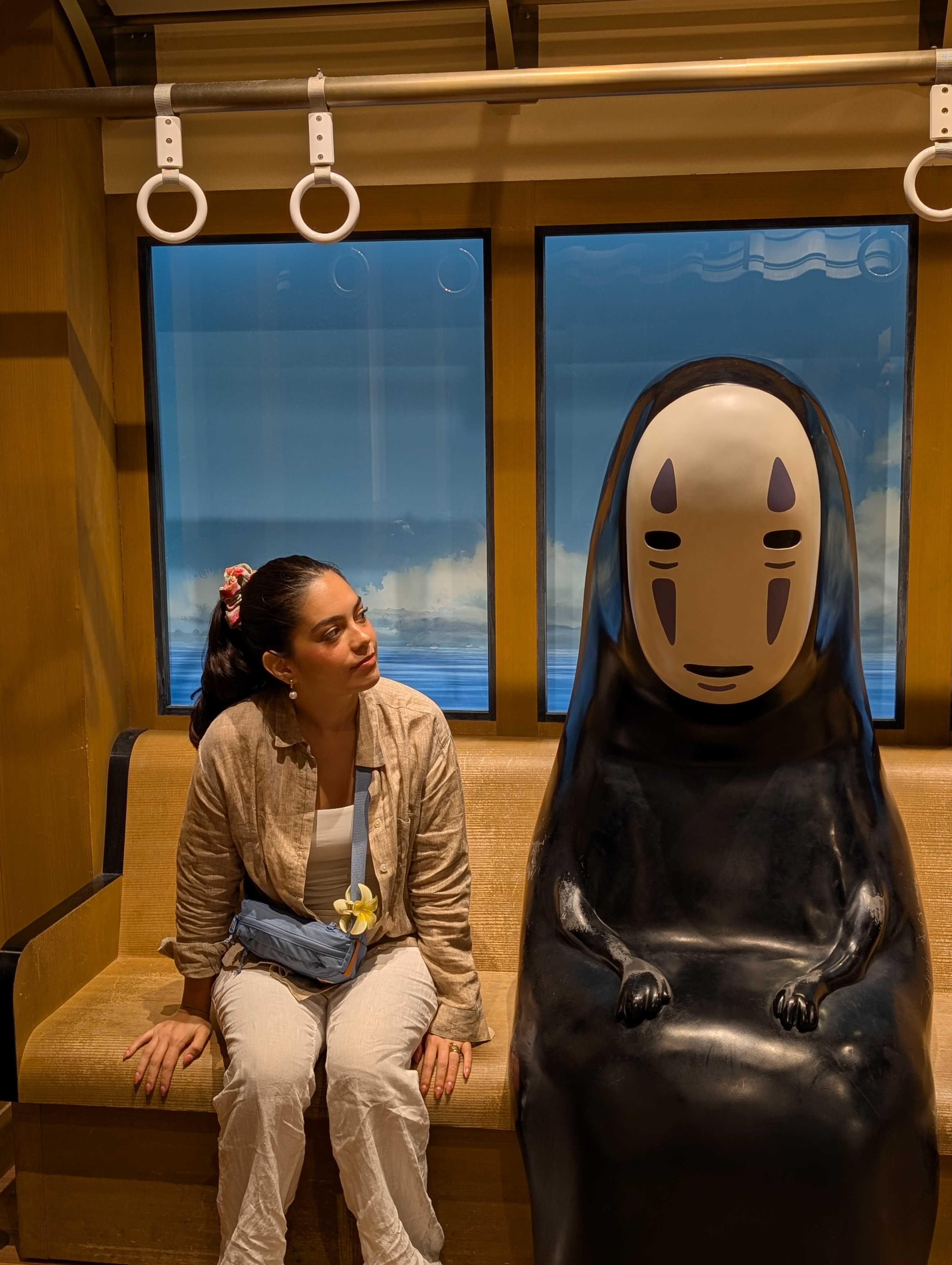 Pierre at the LEGO store holding a Gizmo Gremlins set — the LEGO logo blazing red behind him, his expression suggesting this was an essential purchase