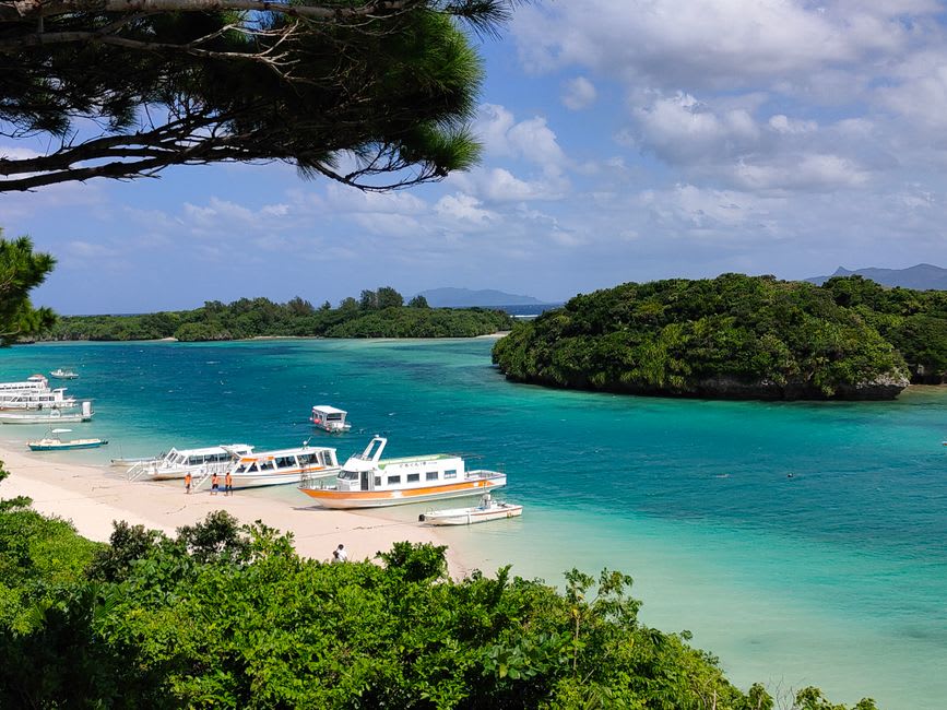 Sightseeing boat threading a narrow channel between pine-covered islets of the Kujūkushima