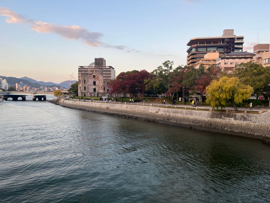 The stilted Fumeikaku hall above Takehara's rooftops at golden hour