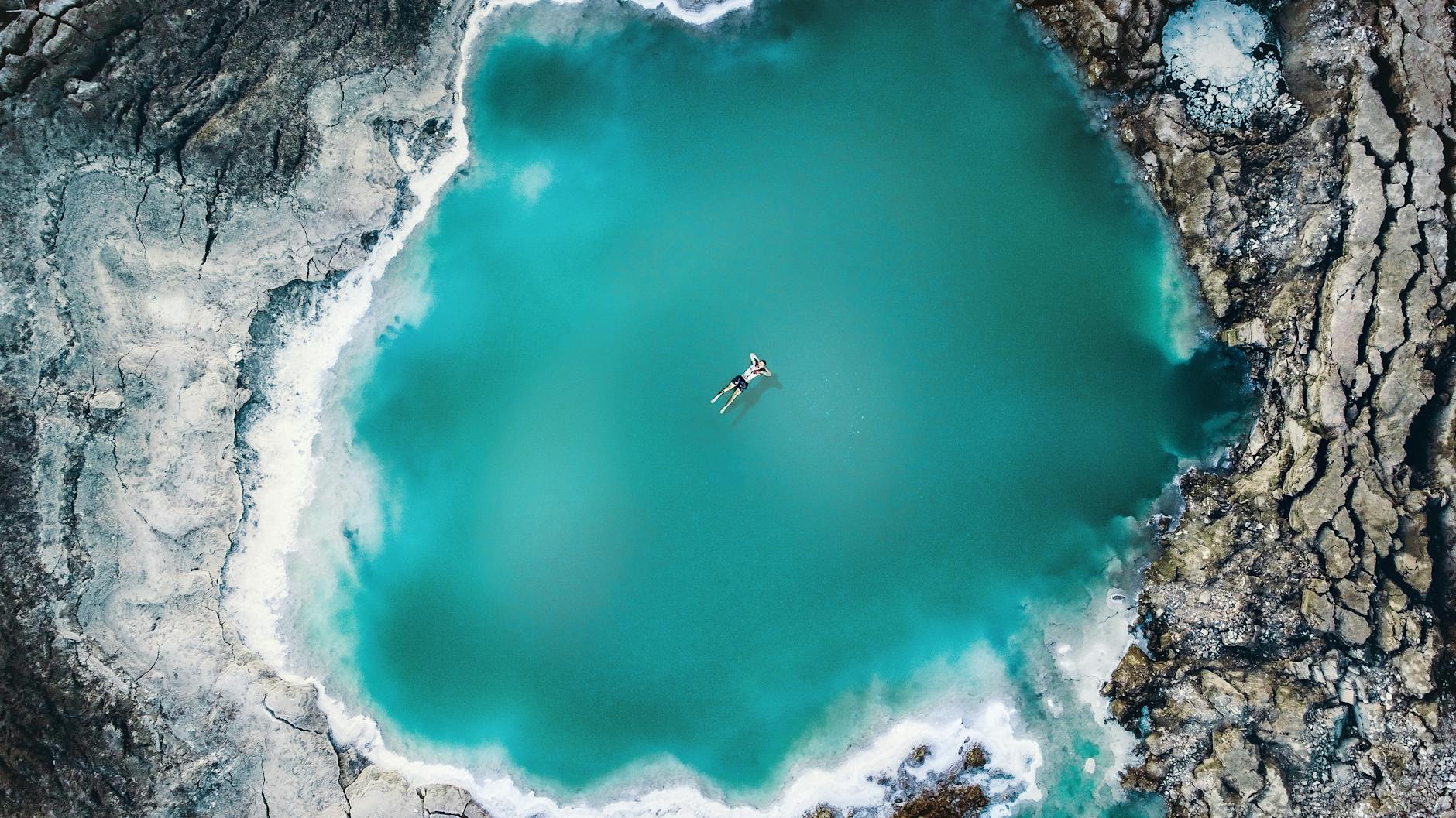 The turquoise waters of the Dead Sea with salt-encrusted shores