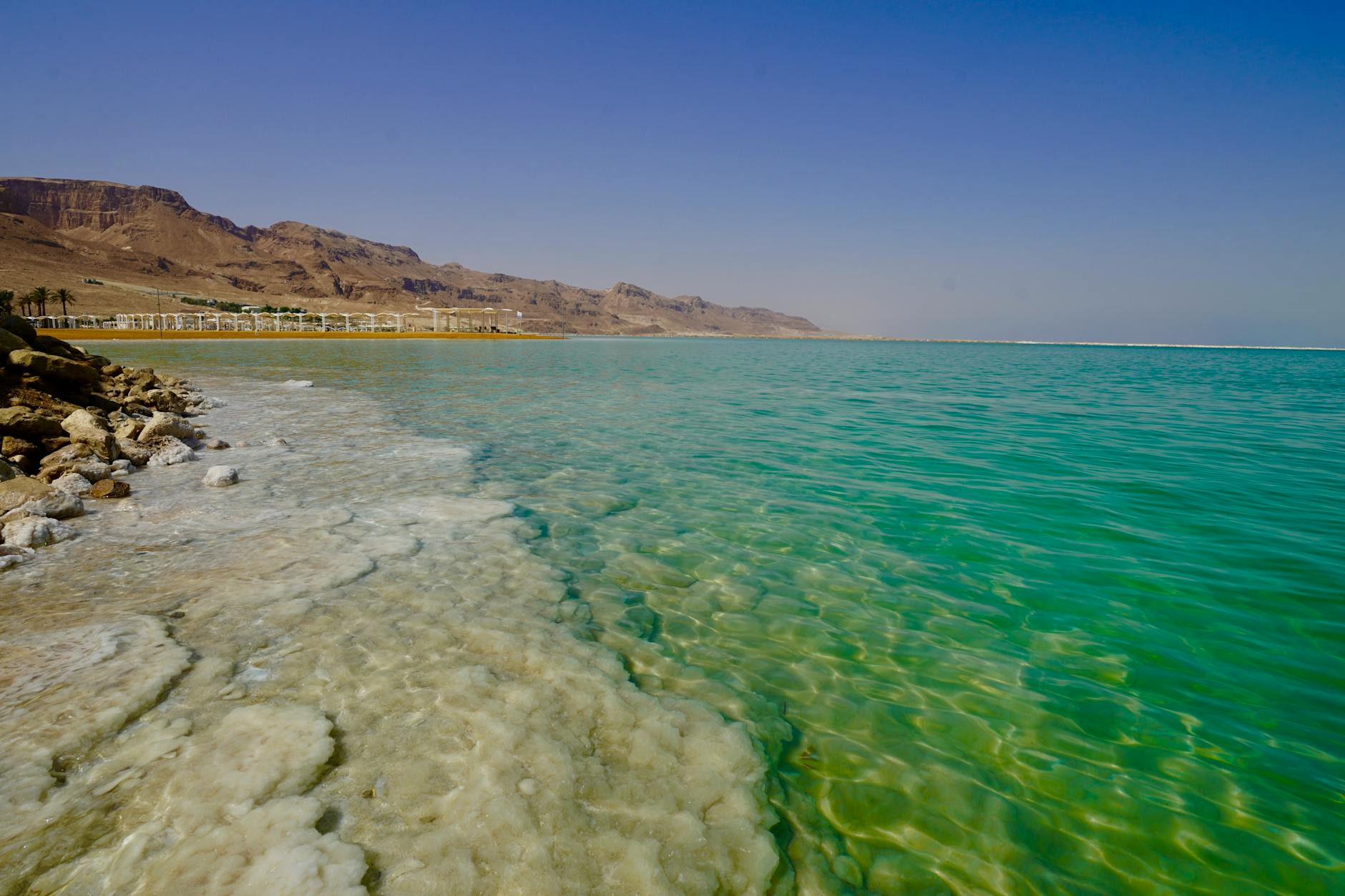 Salt crystal formations along the Dead Sea shoreline at golden hour