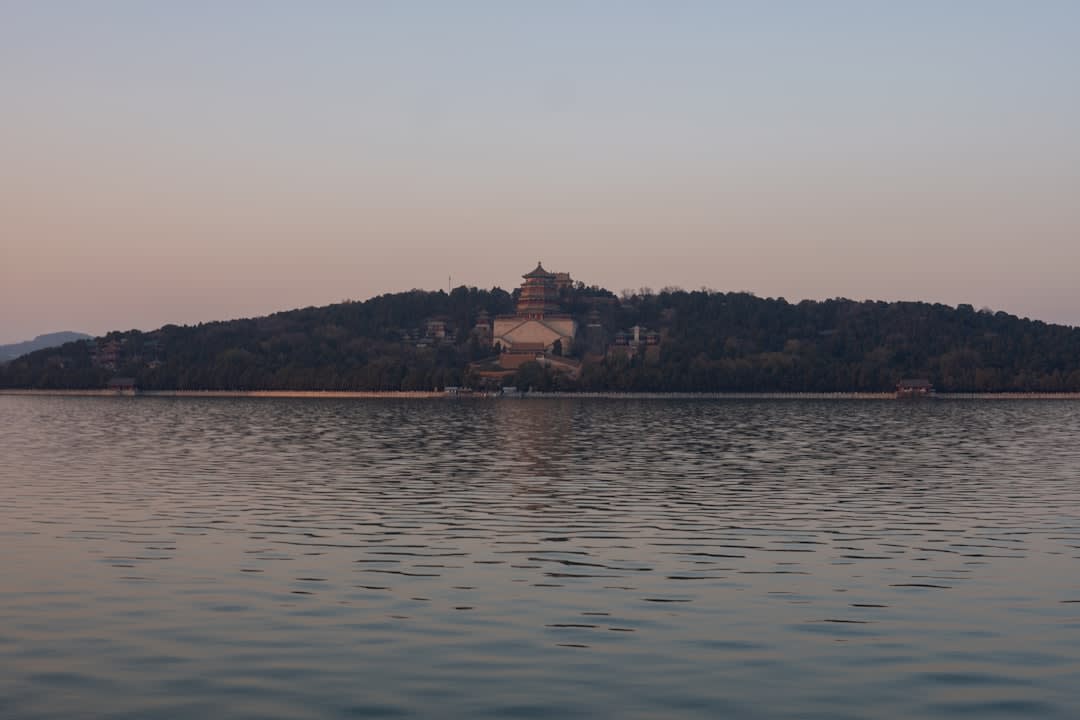 The full terraced structure of Pari Mahal seen from below with Dal Lake and the Himalayas in the background