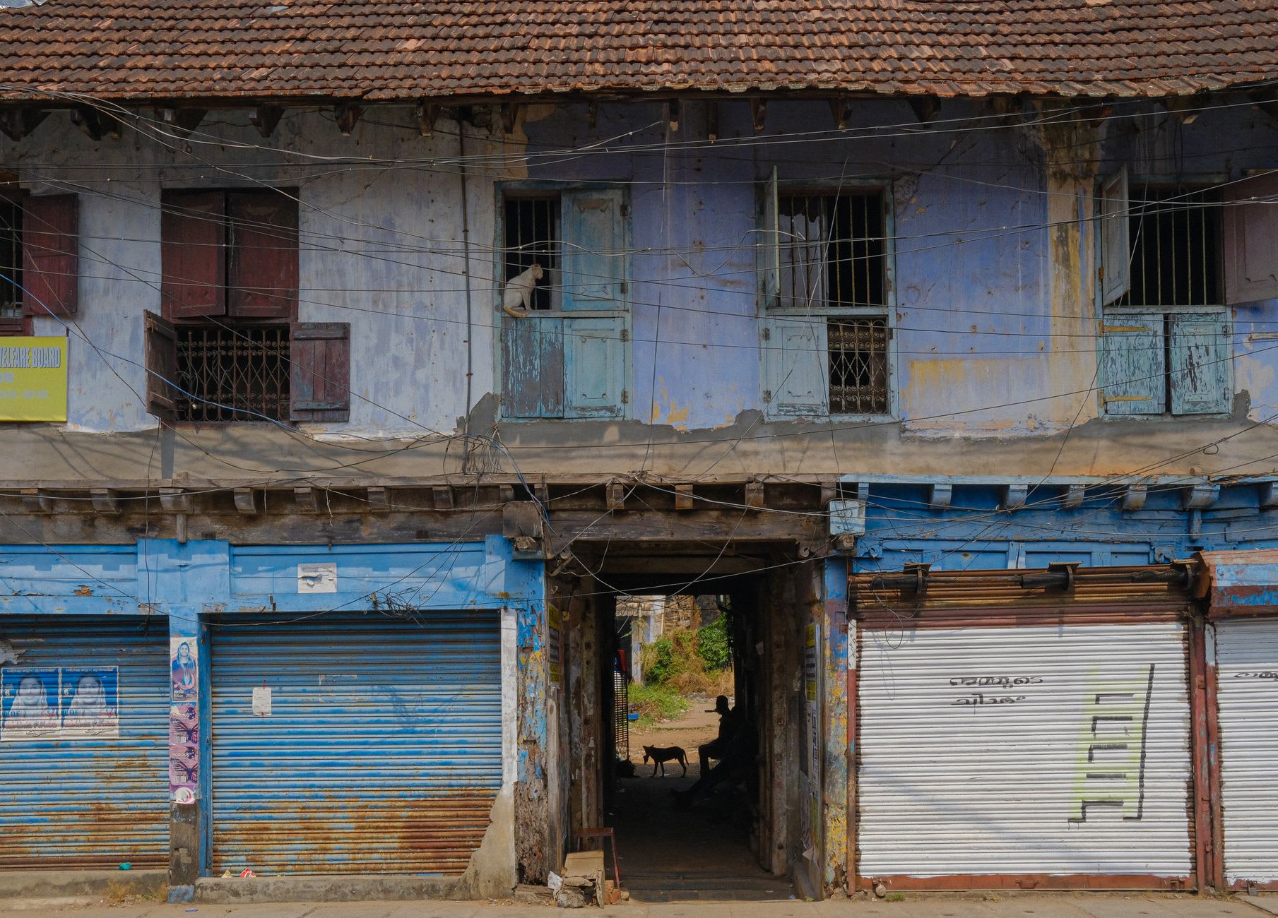 A lantern-lit alley in Fort Kochi's Heritage District with colonial Portuguese architecture and bougainvillea