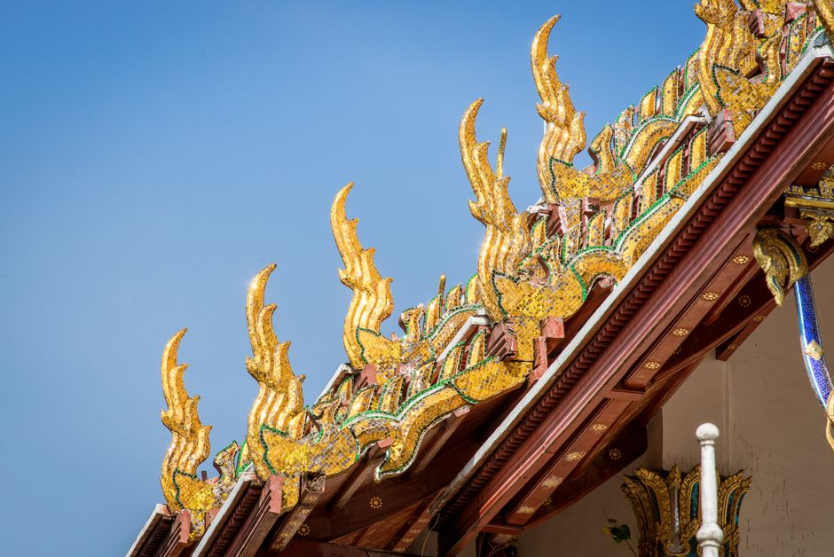 Carved dragons and ornate rooflines at the modern main hall of Wat Plai Laem