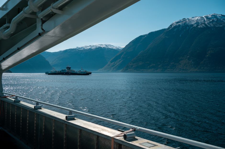 A ferry crossing the calm waters of the Reloncaví fjord from Hornopirén with forested mountains on both sides