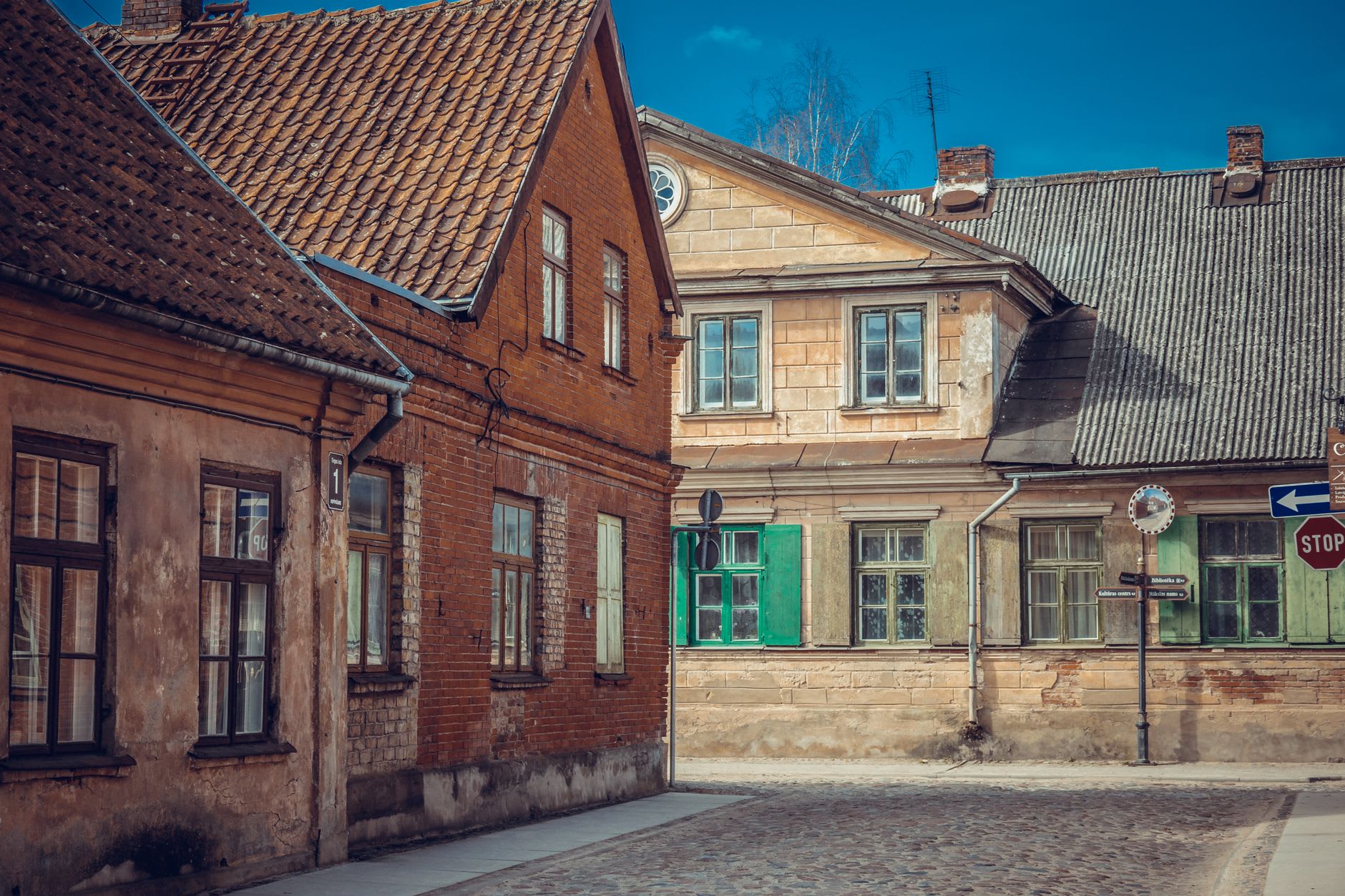 The inner courtyard of the Livonian Order Castle in Ventspils, pale stone walls around a cobbled square