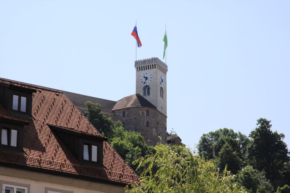 Close view of Vaduz Castle's tower and walls rising above the trees