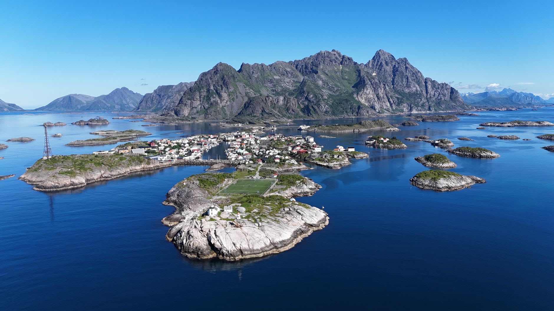 Svolvær fish market and waterfront on a bright winter morning, stalls of fresh Arctic cod, mountains beyond the town
