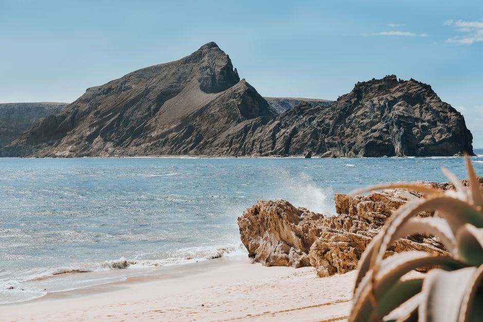 Fine golden sand of Porto Santo beach with gentle waves reaching the shore