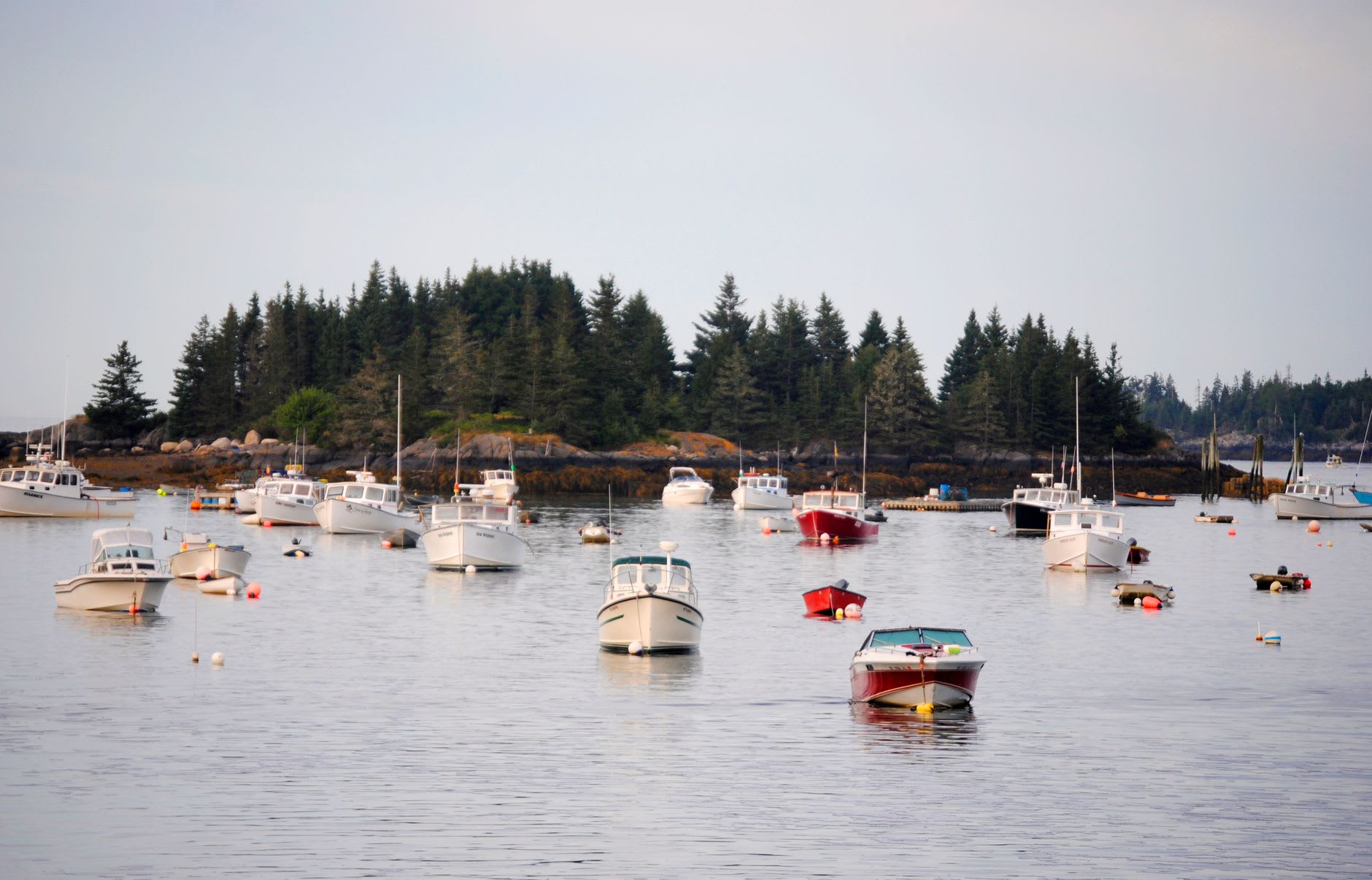 The Kennebunk River at dawn, its waterfront reflections doubled in the still water