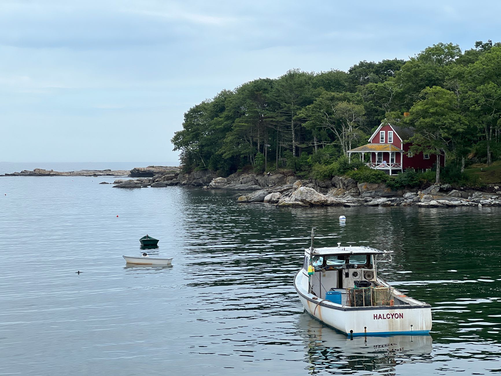 Cape Porpoise harbor at low tide, lobster traps stacked on the dock in the afternoon sun