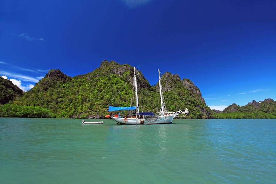 Turquoise waters and limestone islands seen from a boat in the Langkawi archipelago