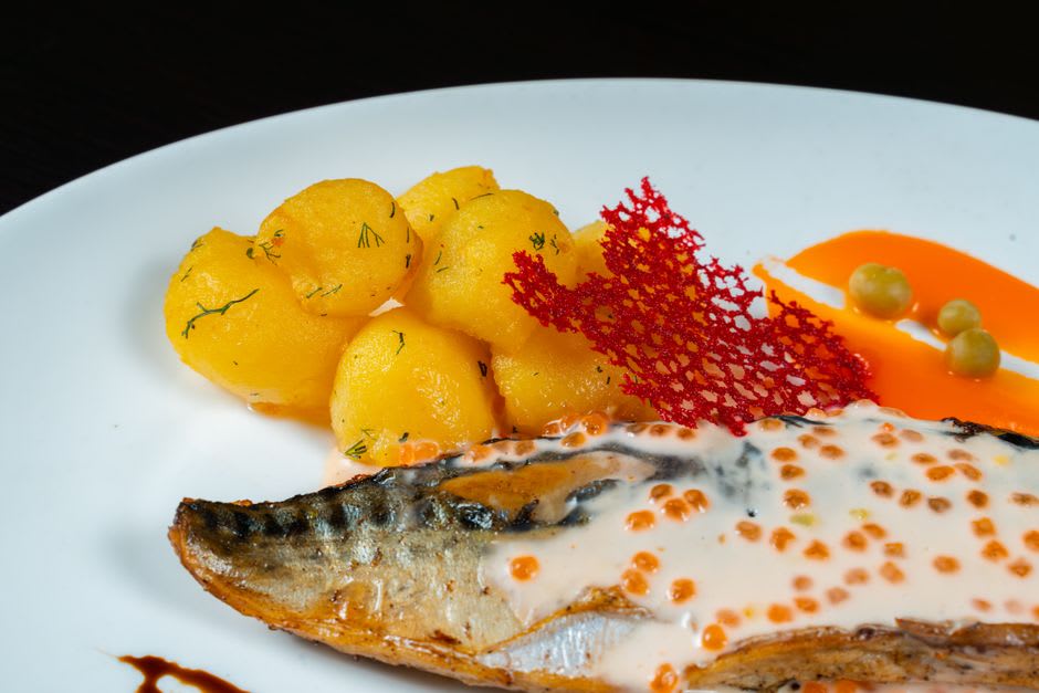 Pounded taro mixed with coconut cream served on a woven mat alongside grilled reef fish on Namorik
