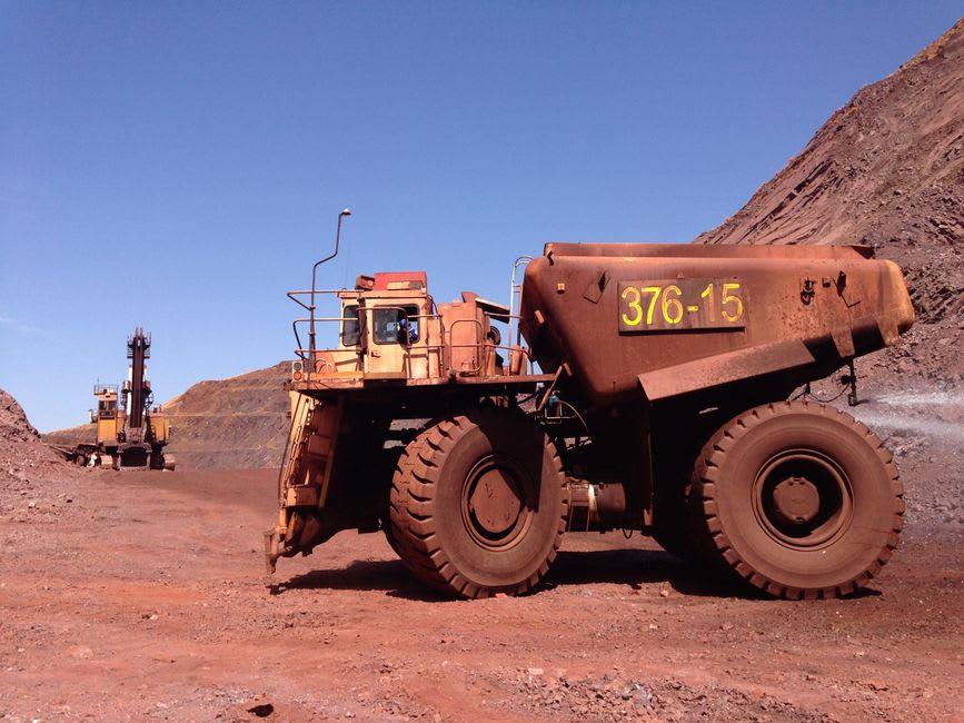 The Iron Ore Train winding past Ben Amera at dusk, dust rising behind it