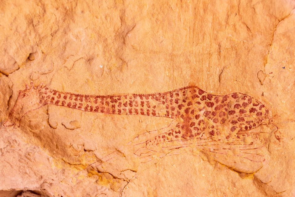 Faint prehistoric petroglyphs carved into rock near the base of Ben Amera