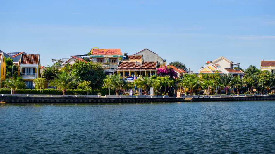 Weathered French colonial shophouses along Tan Chau's riverfront market street