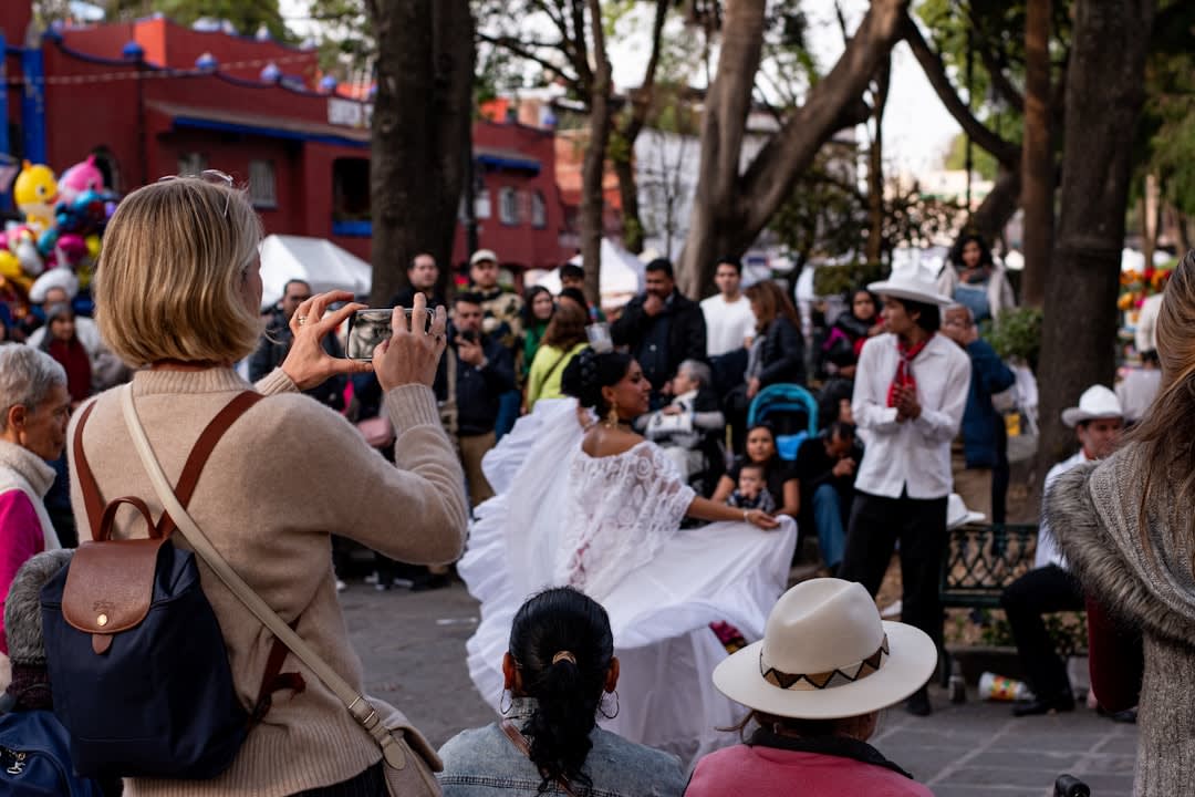 A Yaqui Pascola dancer in carved wooden mask performs in a village plaza near Cócorit, the ceremony continuing into the late Sonoran afternoon