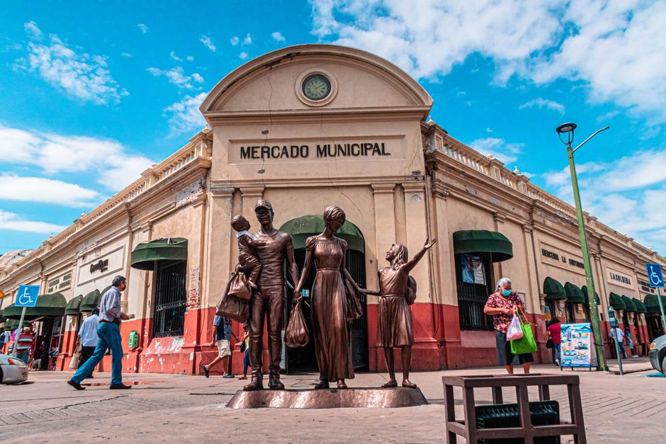 Evening light on Plaza Juárez in central Cananea with locals gathered at outdoor tables near the church