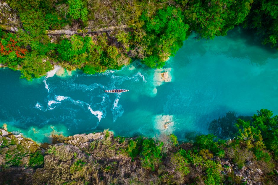 A clear river and small waterfall dropping through green subtropical forest in a ravine near Chapulhuacán