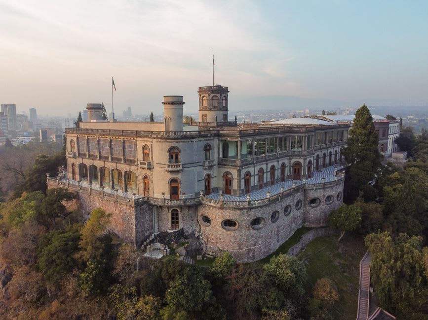 Chapultepec Castle seen through the ahuehuete canopy, its stone towers catching the morning light