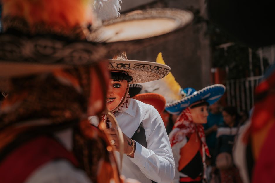 A display inside the Museo de las Culturas Afromestizas showing traditional masks and historical photographs of Costa Chica communities.
