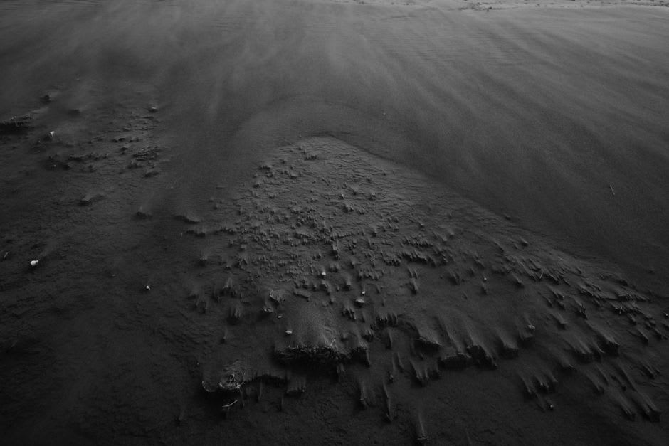 Black volcanic sand and Pacific surf at Cuyutlán's beach at golden hour