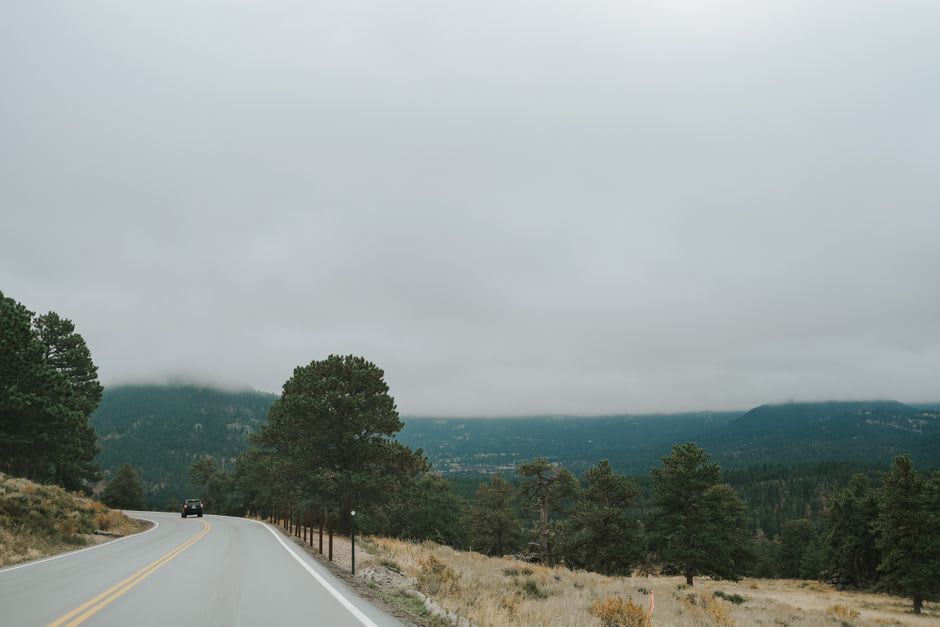 Hairpin switchbacks on El Espinazo del Diablo, old Highway 40, with layered mountain ridges disappearing into cloud in the distance