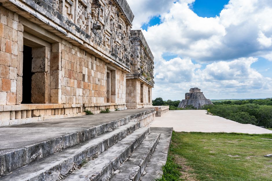The Arch of Kabah standing alone in an open field, a corbelled Maya arch with no fence around it