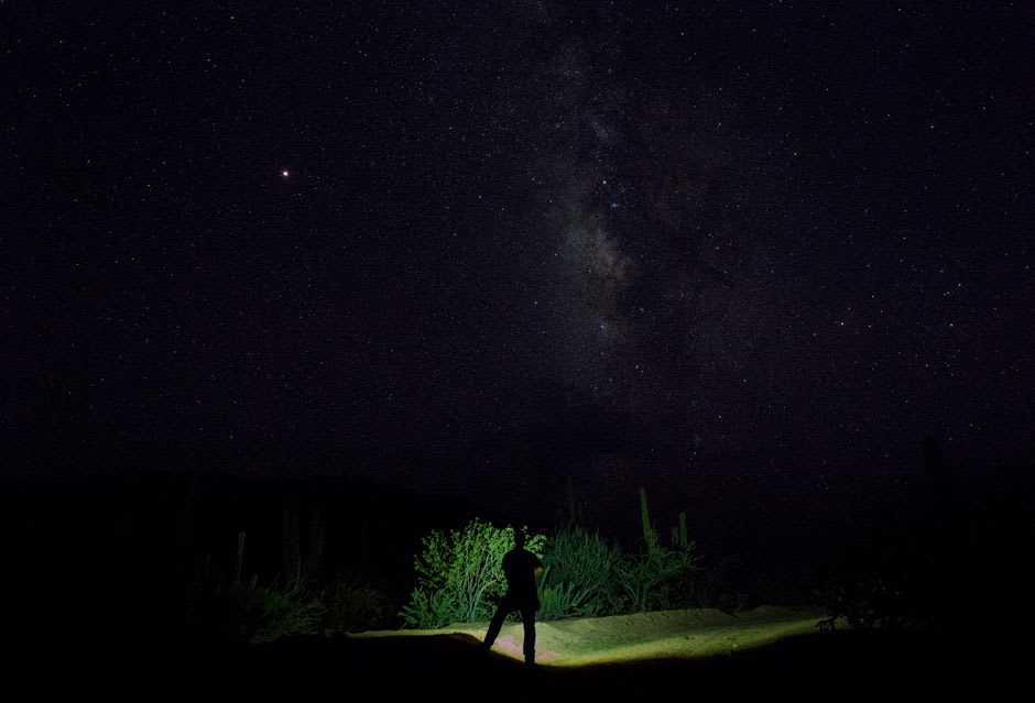 The night sky over La Ribera blazing with stars above the quiet coastal village and the dark water beyond