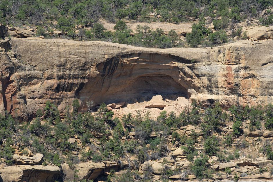 Stone chambers built into an overhanging cliff face at Cueva de los Portales near Madera, Chihuahua