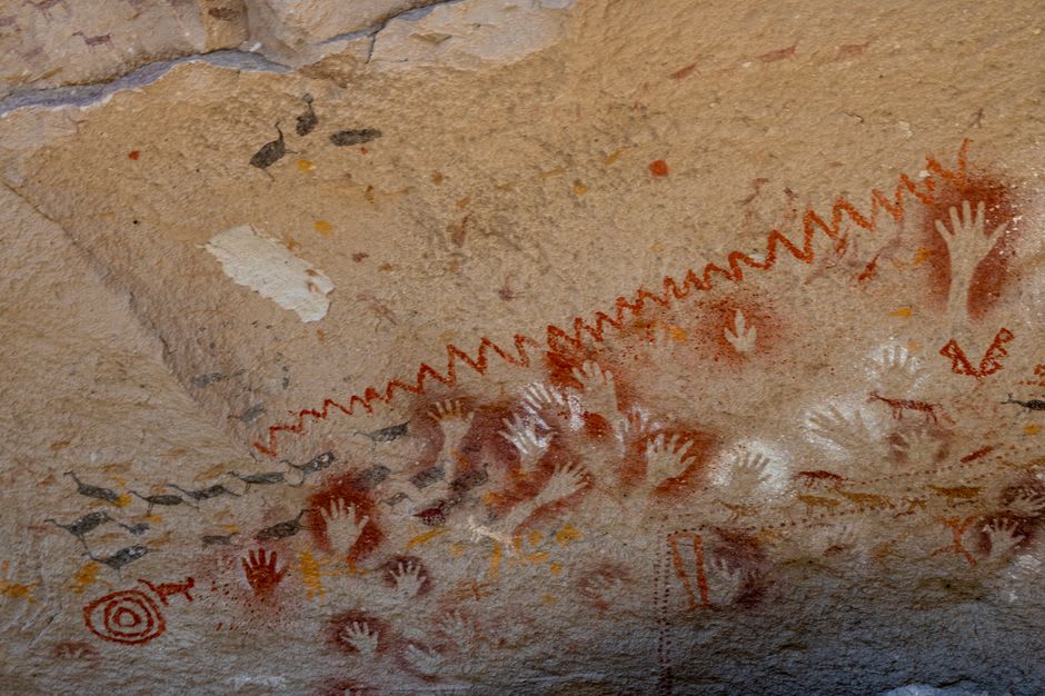 Ancient limestone cave entrance in the desert hills outside Monclova, Coahuila, surrounded by dry scrub and pale rock
