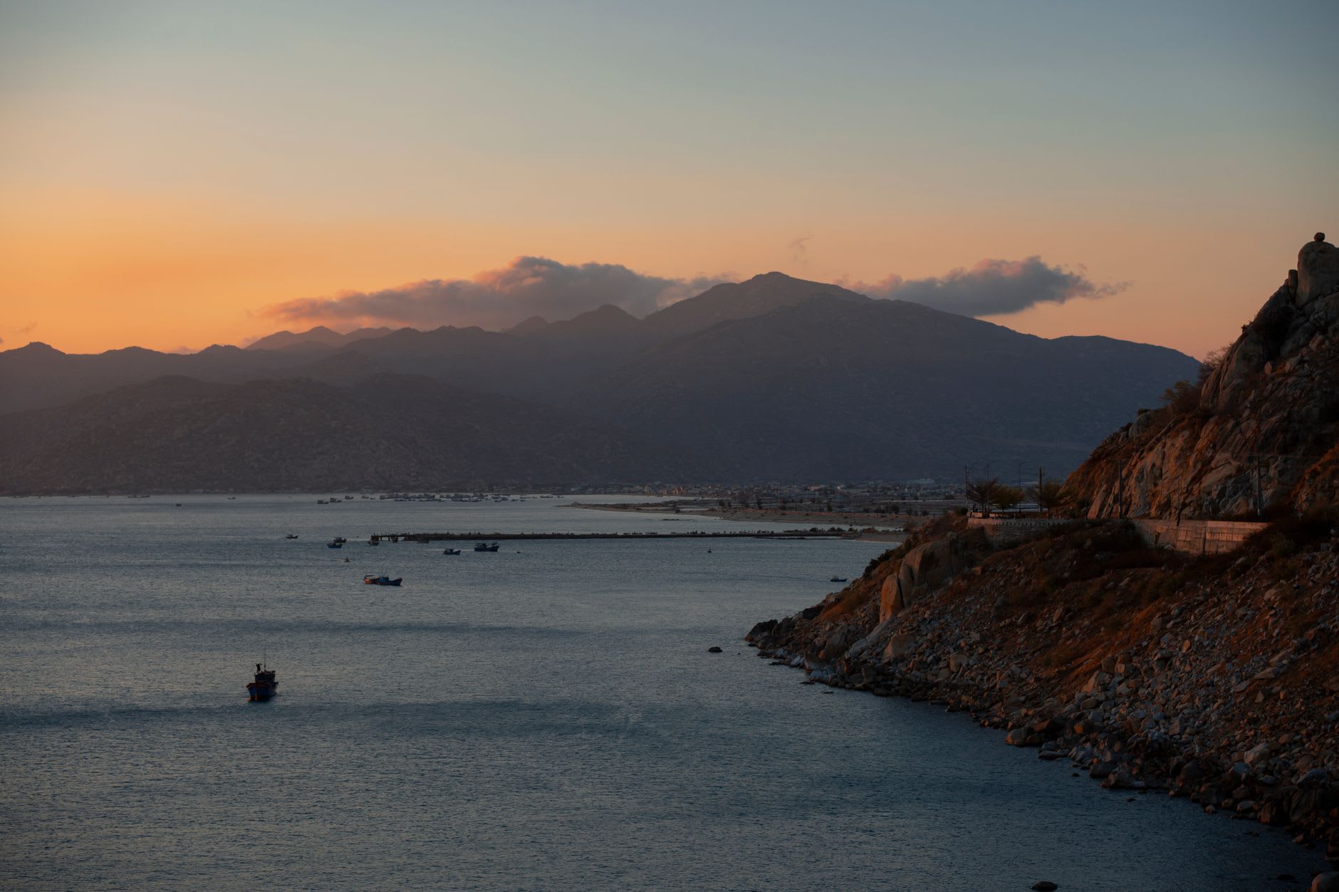 Fishing pangas moored at the southern beach at dawn, Sierra Madre foothills behind them