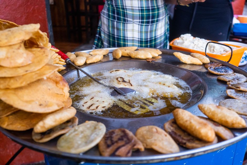 A plate of empanadas de cazón with habanero salsa at a malecón stand in Seybaplaya