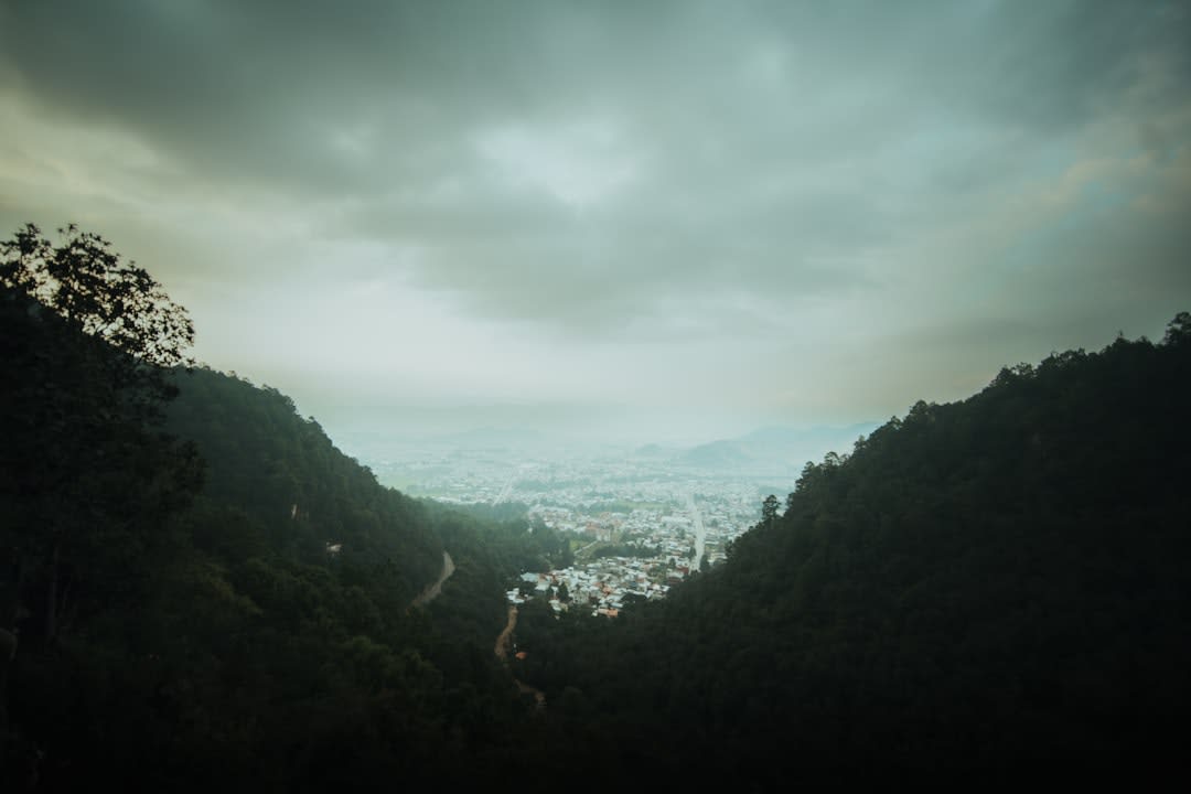 The view from the Tepozteco pyramid looking down over the red-tiled roofs of Tepoztlán and the forested valley