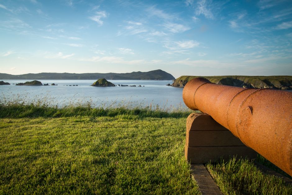 Rusted Japanese artillery gun overlooking the invasion beaches of Saipan with the reef visible offshore