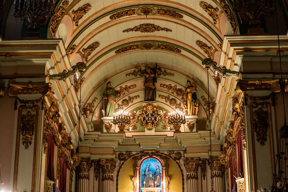 Gold-leafed baroque interior of a church in Mariana with ornate ceiling paintings