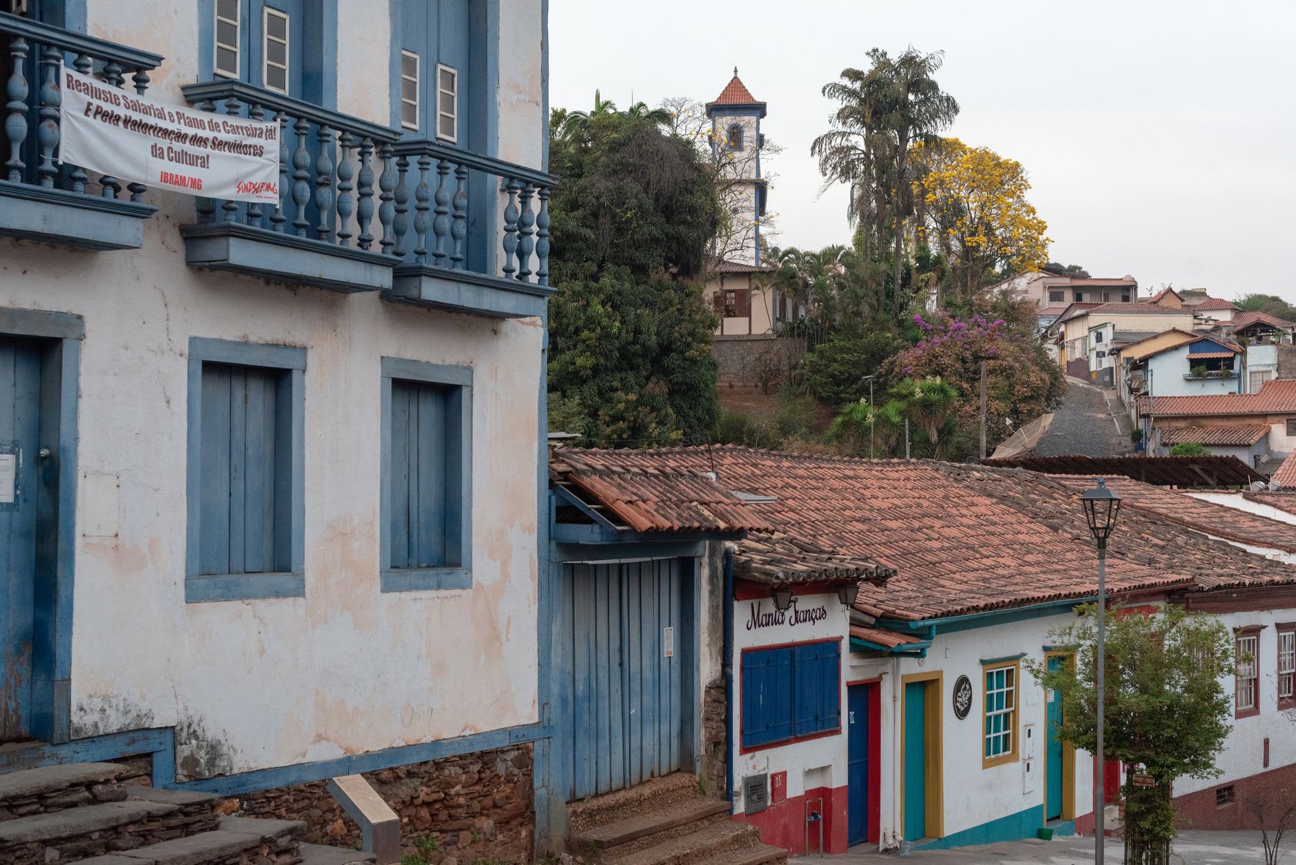 The steam locomotive of the Maria-Fumaça about to depart São João del-Rei station on the historic Tiradentes line, smoke rising in the morning air