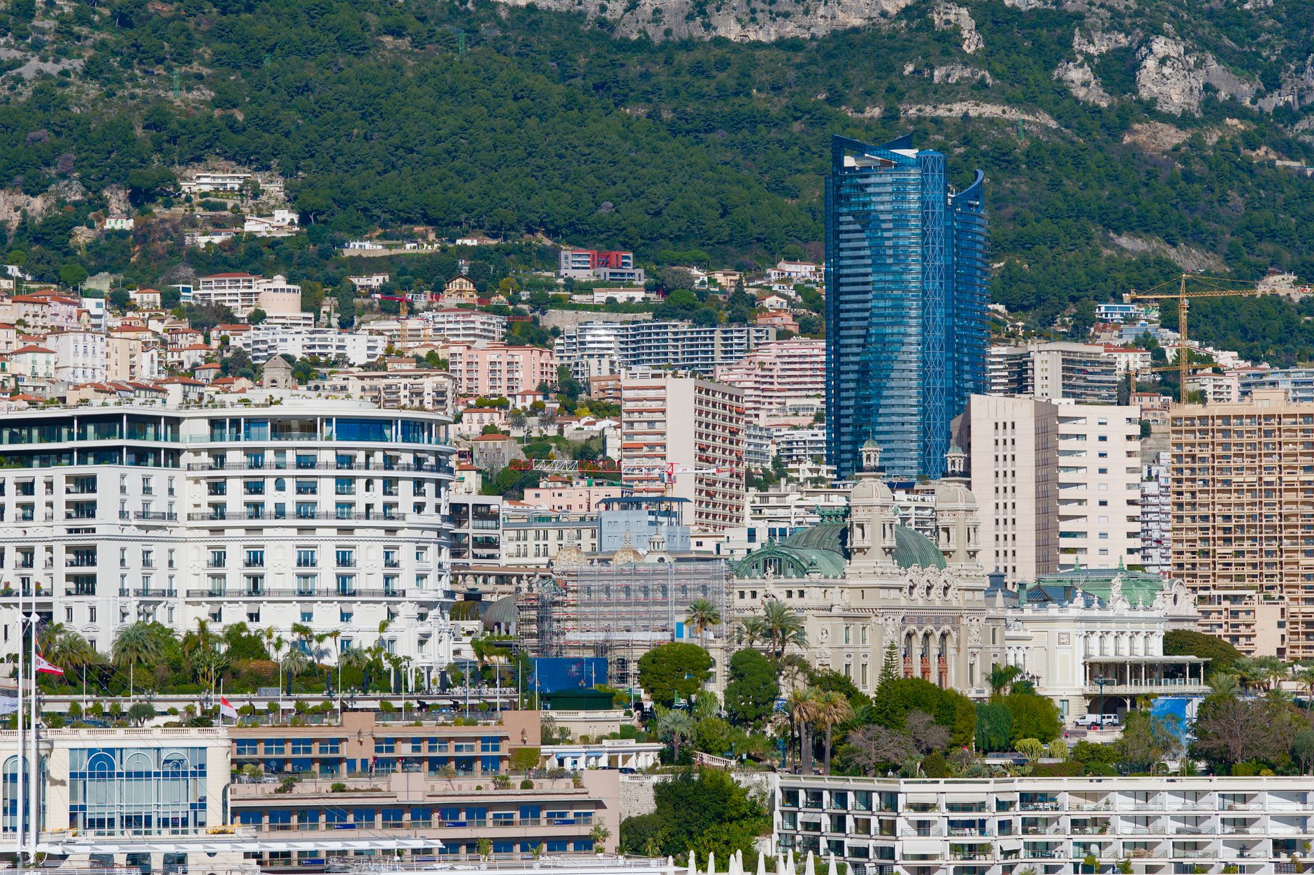 The Casino de Monte-Carlo facade with its ornate Belle Époque towers reflected in the plaza fountains