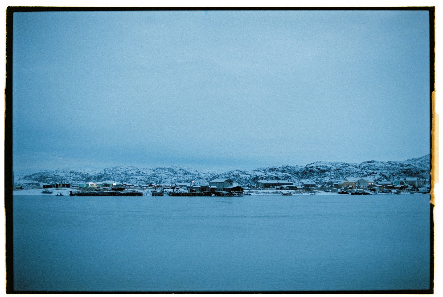 The Kola local history museum's collection — old maps, icons, wooden objects, and photographs of 19th-century settlements along the river